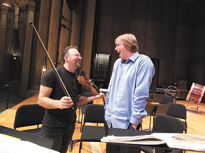 Spokane Symphony concertmaster Mateusz Wolski, left, and Music Director Eckart Preu share a laugh during rehearsals in 2014.