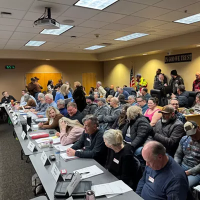 Image: A woman who heckled Idaho lawmakers at a Coeur d'Alene town hall was dragged out by unidentified men, fueling a First Amendment debate