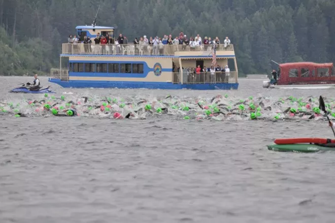 ironman-swimmers-with-cruise-boat-backdrop-2d347ff0d10f1bf.webp