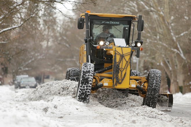 Who is responsible for clearing icy sidewalks and buried bus stops?