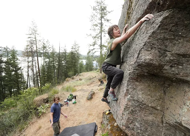 An indoor rock climber tackles Tubbs Hill bouldering in Coeur d’Alene, led by local guidebook author Owen Harro