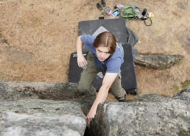 An indoor rock climber tackles Tubbs Hill bouldering in Coeur d’Alene, led by local guidebook author Owen Harro