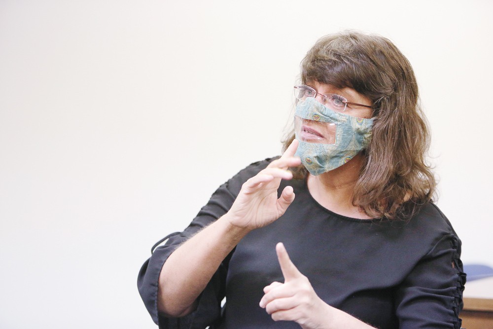 College student makes face masks with plastic window for deaf and